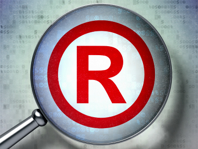 Law concept: magnifying optical glass with Registered icon on digital background, 3d render